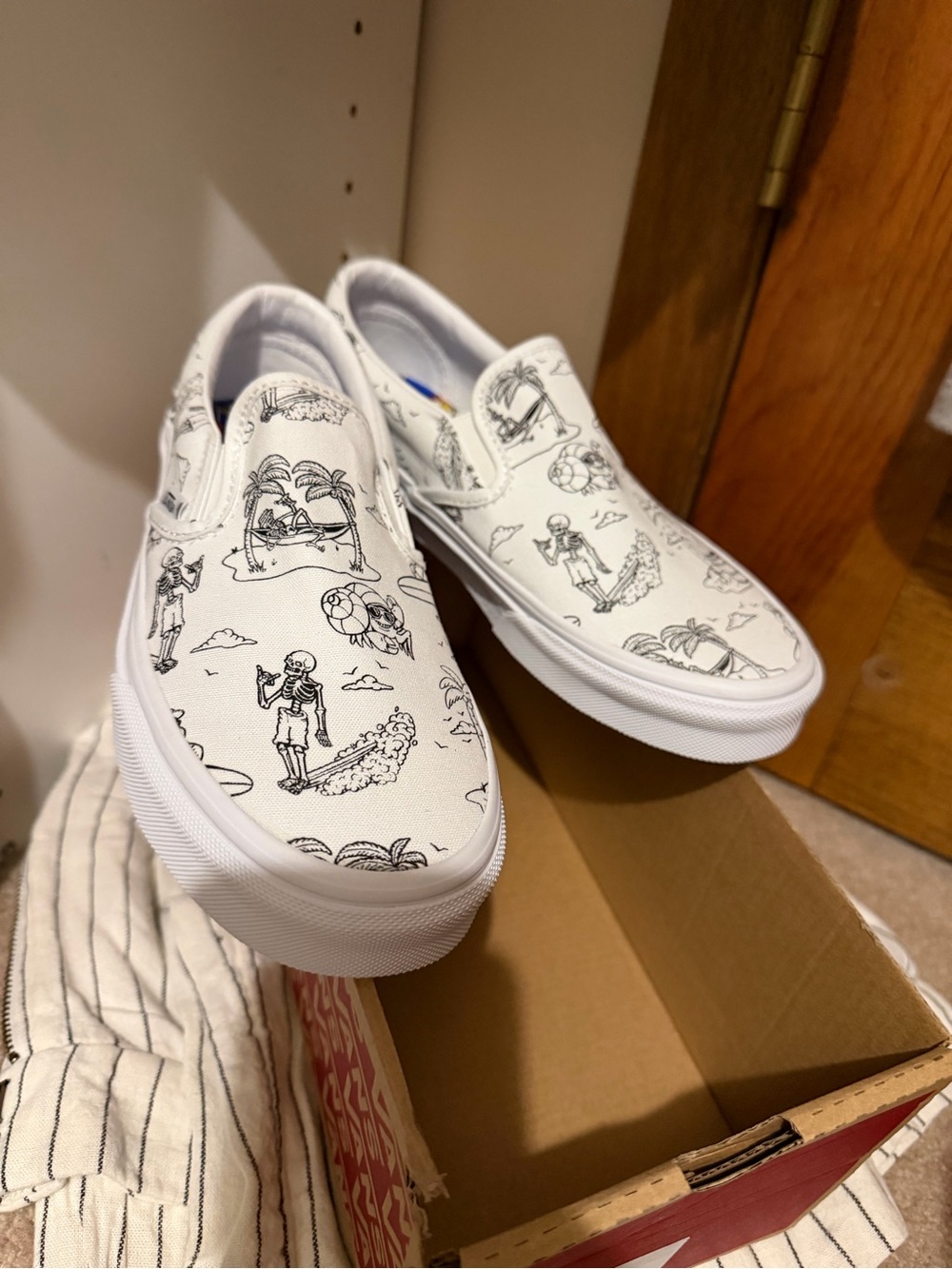 Vans White Slip-On Sneakers with Black skeleton doodles